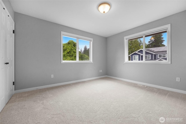 7709 NE 170th St, Kenmore, WA 98028 - empty room with healthy amount of natural light and carpet floors