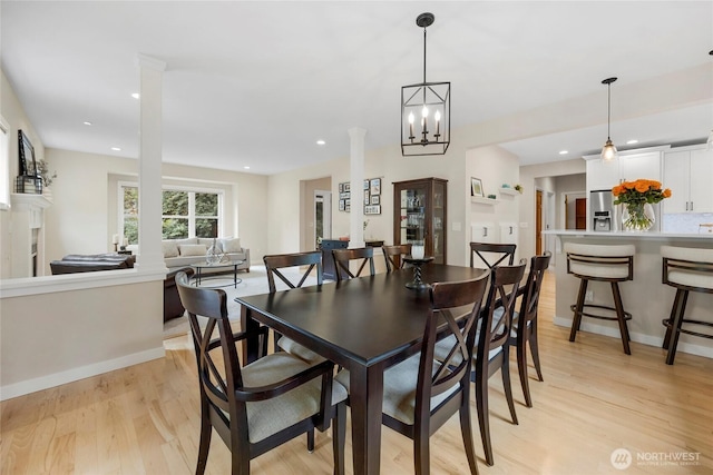 7709 NE 170th St, Kenmore, WA 98028 - dining room featuring light wood finished floors, decorative columns, and recessed lighting