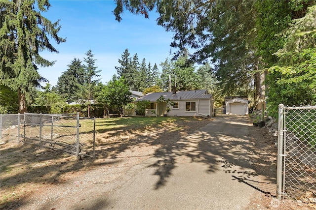 1308 S 359th St, Federal Way, WA 98003 - single story home featuring a gate, driveway, an outdoor structure, a detached garage, and a metal roof