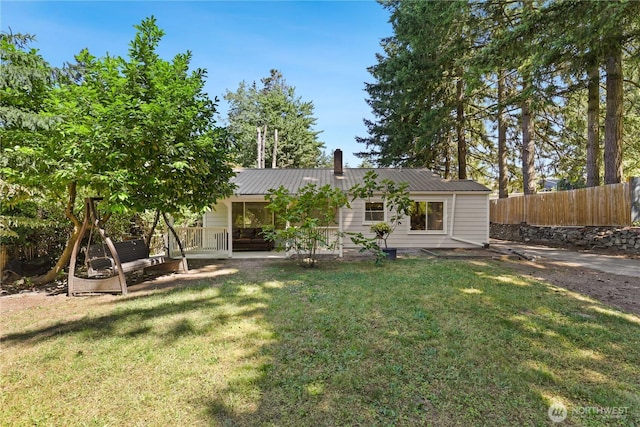 1308 S 359th St, Federal Way, WA 98003 - rear view of house featuring a metal roof and a chimney