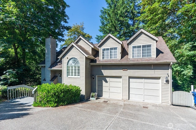4123 150th Ave SE, Bellevue, WA 98006 - view of front facade with a gate, concrete driveway, a chimney, and roof with shingles