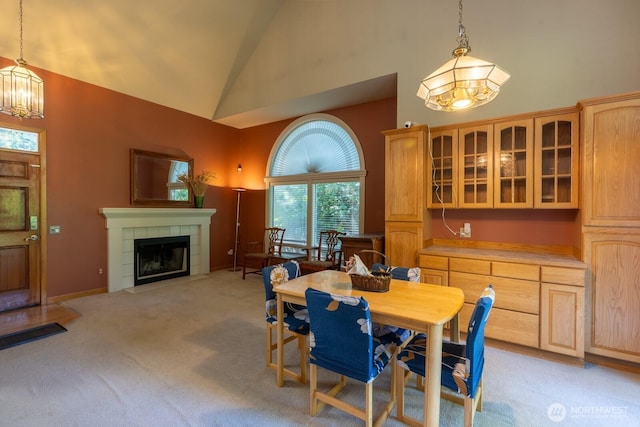 4123 150th Ave SE, Bellevue, WA 98006 - dining area featuring a chandelier, high vaulted ceiling, light colored carpet, and a tile fireplace