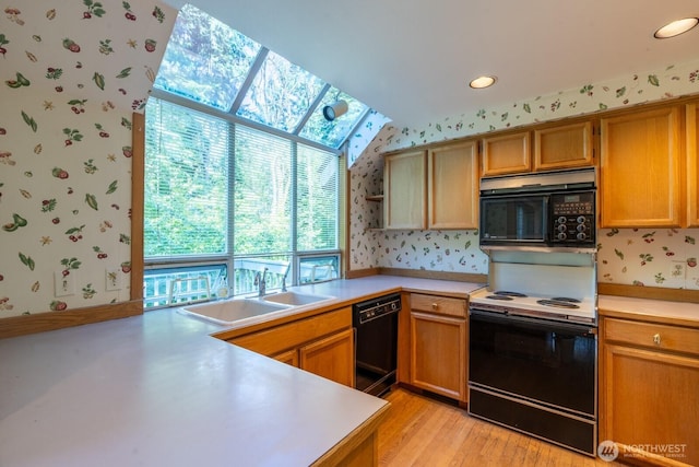 4123 150th Ave SE, Bellevue, WA 98006 - kitchen with wallpapered walls, black appliances, light countertops, open shelves, and light wood-style floors
