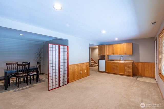 4123 150th Ave SE, Bellevue, WA 98006 - kitchen with wood walls, wainscoting, light carpet, recessed lighting, and refrigerator