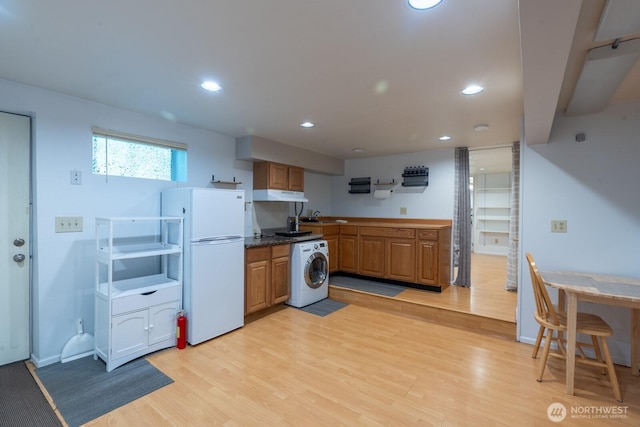 4123 150th Ave SE, Bellevue, WA 98006 - kitchen with freestanding refrigerator, washer / dryer, under cabinet range hood, light wood finished floors, and recessed lighting