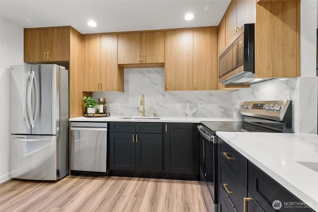 10305 NE 16th St Unit I6, Bellevue, WA 98004 - kitchen featuring appliances with stainless steel finishes, decorative backsplash, light wood finished floors, recessed lighting, and light stone countertops