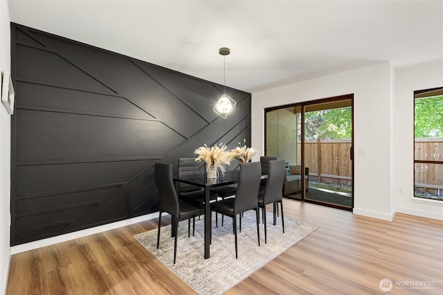 10305 NE 16th St Unit I6, Bellevue, WA 98004 - dining area with light wood-style flooring and a chandelier