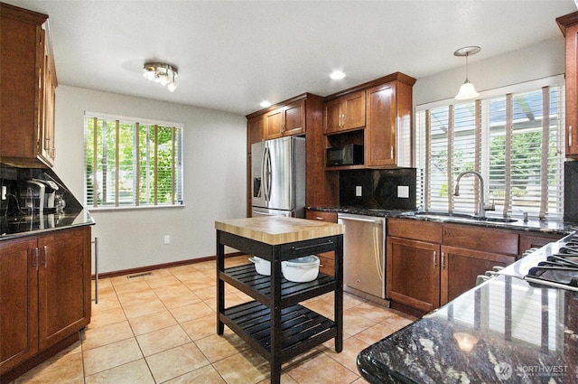 37404 18th Ave S, Federal Way, WA 98003 - kitchen with appliances with stainless steel finishes, tasteful backsplash, light tile patterned flooring, dark stone counters, and recessed lighting