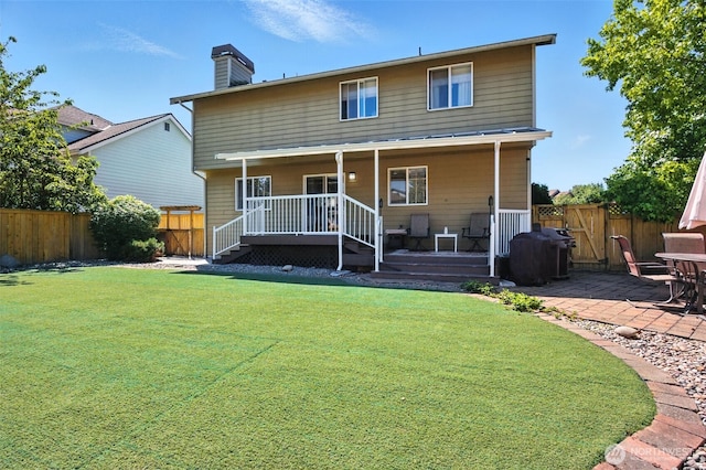37404 18th Ave S, Federal Way, WA 98003 - back of property with a chimney, a fenced backyard, and a patio