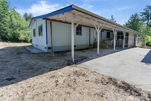 151 Dietz Dr, Quilcene, WA 98376 - back of property with crawl space and an attached carport