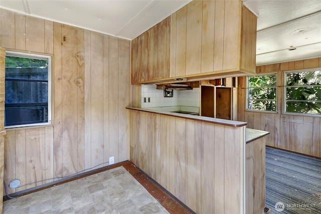 151 Dietz Dr, Quilcene, WA 98376 - kitchen with wood walls, light brown cabinetry, and cooktop