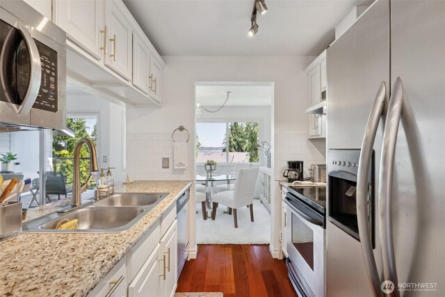 4181 W Lake Sammamish Pkwy SE Unit B301, Bellevue, WA 98008 - kitchen with appliances with stainless steel finishes, dark wood finished floors, white cabinets, and tasteful backsplash