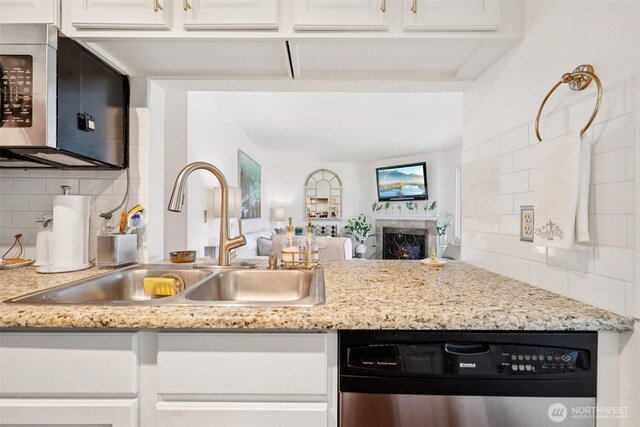 4181 W Lake Sammamish Pkwy SE Unit B301, Bellevue, WA 98008 - kitchen featuring stainless steel appliances, tasteful backsplash, white cabinetry, open floor plan, and light stone counters
