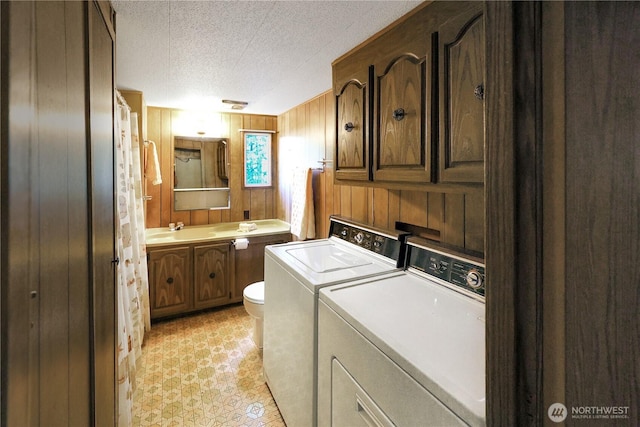 31809 148th Way SE, Auburn, WA 98092 - laundry room featuring a textured ceiling, wooden walls, and washing machine and clothes dryer