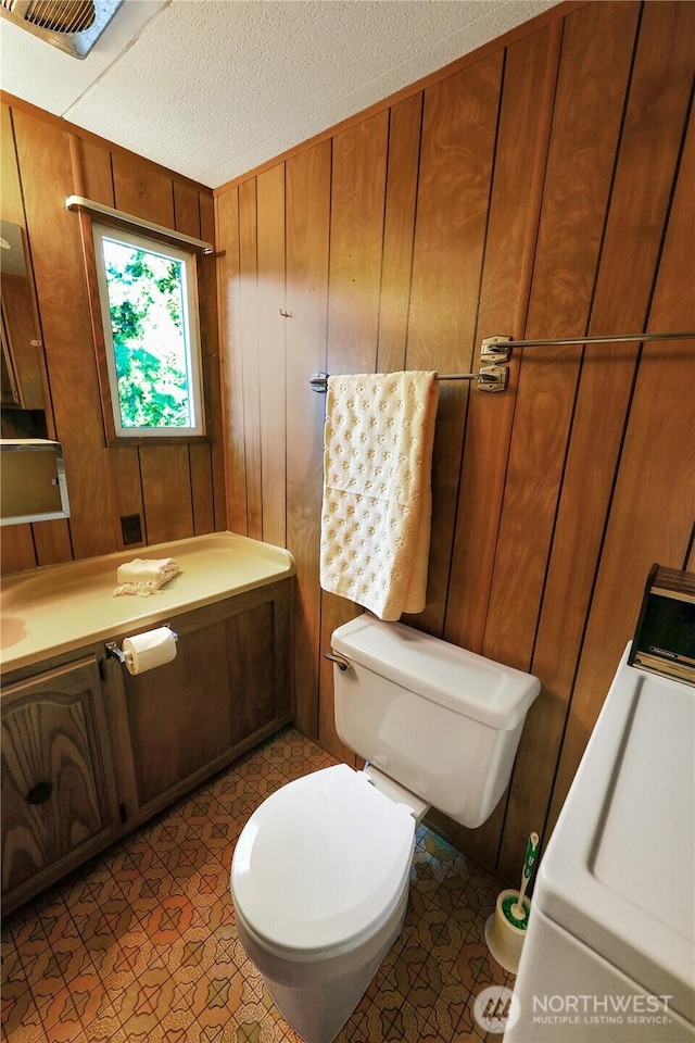 31809 148th Way SE, Auburn, WA 98092 - bathroom with wooden walls, washer / dryer, vanity, and a textured ceiling