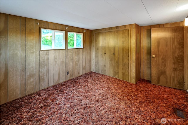 31809 148th Way SE, Auburn, WA 98092 - unfurnished bedroom with wooden walls, carpet floors, and a closet