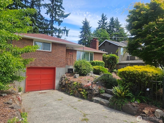 12540 3rd Ave NW, Seattle, WA 98177 - ranch-style house featuring an attached garage, brick siding, and driveway
