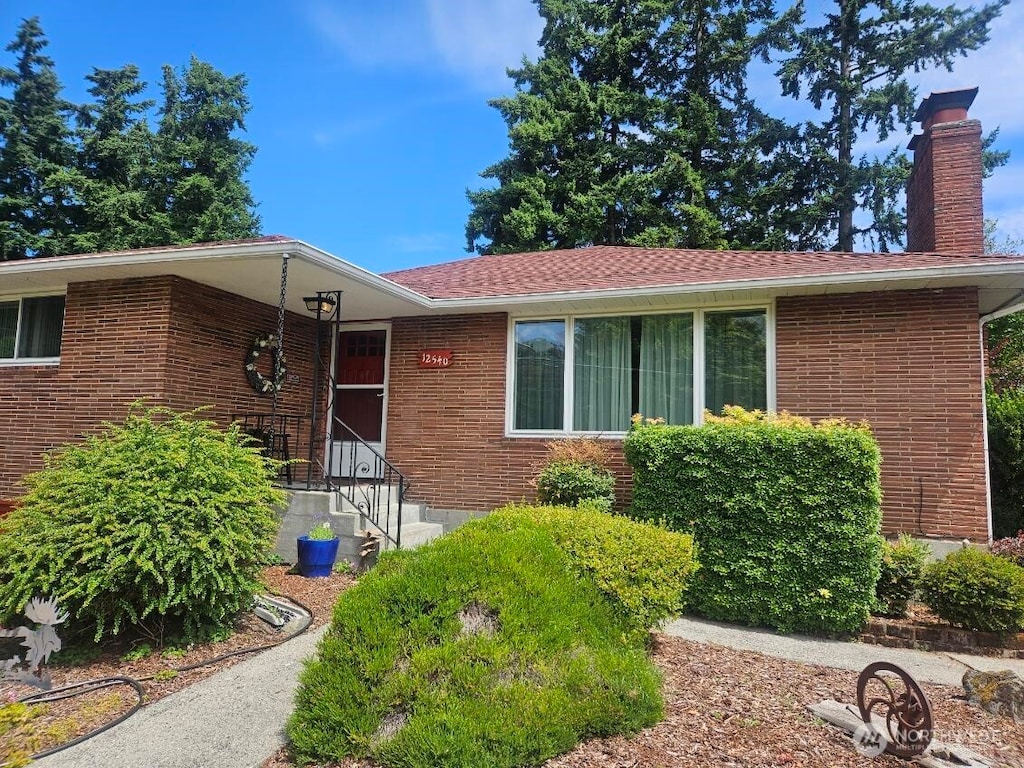 12540 3rd Ave NW, Seattle, WA 98177 - view of front of property featuring brick siding and a chimney