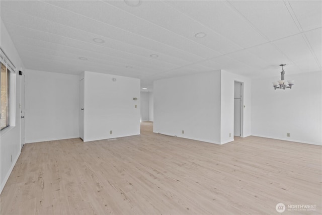1402 22nd St NE Unit 39, Auburn, WA 98002 - spare room featuring a chandelier and light wood-type flooring