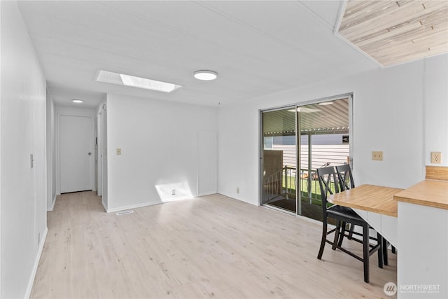 1402 22nd St NE Unit 39, Auburn, WA 98002 - spare room featuring a skylight and wood finished floors