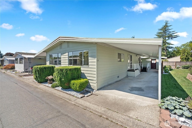 1402 22nd St NE Unit 39, Auburn, WA 98002 - view of front of house featuring an attached carport and concrete driveway