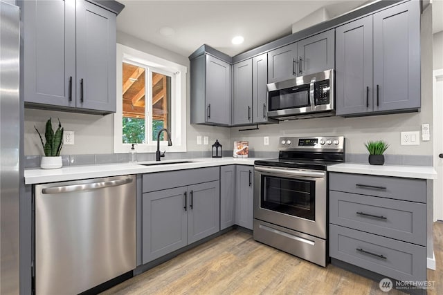 7113 E Dakota St, Port Orchard, WA 98366 - kitchen with stainless steel appliances, gray cabinets, light countertops, light wood finished floors, and recessed lighting