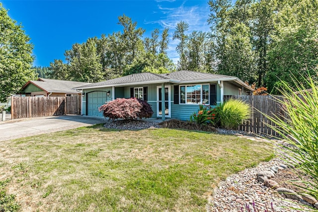 406 Brown Way SE, Orting, WA 98360 - ranch-style house featuring a garage and concrete driveway