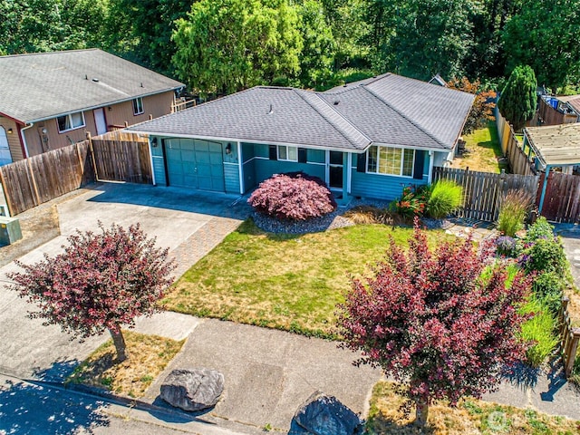 406 Brown Way SE, Orting, WA 98360 - ranch-style house with a garage, concrete driveway, and roof with shingles