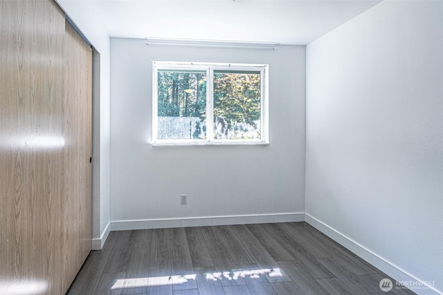 406 Brown Way SE, Orting, WA 98360 - unfurnished room with dark wood-style floors and baseboards