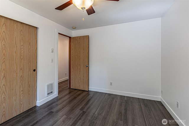 406 Brown Way SE, Orting, WA 98360 - unfurnished bedroom with dark wood-style floors, a closet, and ceiling fan