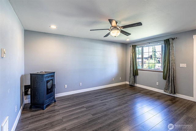 406 Brown Way SE, Orting, WA 98360 - spare room featuring ceiling fan, a wood stove, dark wood-style flooring, and recessed lighting