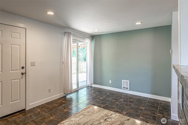 406 Brown Way SE, Orting, WA 98360 - empty room with recessed lighting and dark stone finish flooring