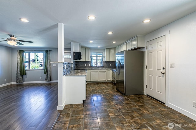 406 Brown Way SE, Orting, WA 98360 - kitchen featuring stainless steel fridge with ice dispenser, a ceiling fan, light stone countertops, recessed lighting, and tasteful backsplash