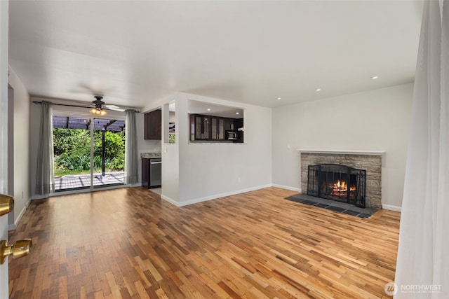 4006 147th Pl, Bellevue, WA 98006 - unfurnished living room featuring wood finished floors, a stone fireplace, ceiling fan, and recessed lighting