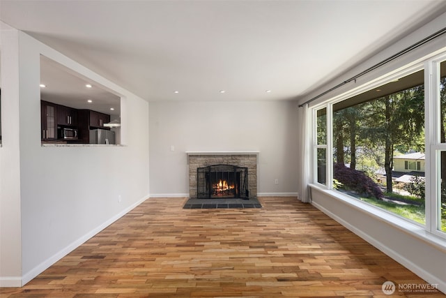 4006 147th Pl, Bellevue, WA 98006 - unfurnished living room with plenty of natural light, light wood-type flooring, recessed lighting, and a fireplace