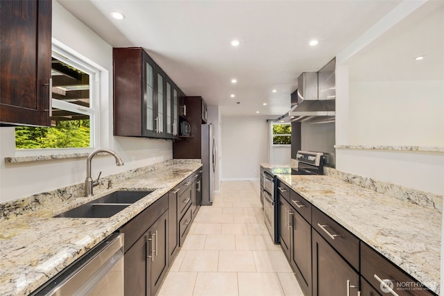 4006 147th Pl, Bellevue, WA 98006 - kitchen with stainless steel appliances, wall chimney exhaust hood, recessed lighting, light stone counters, and dark brown cabinetry
