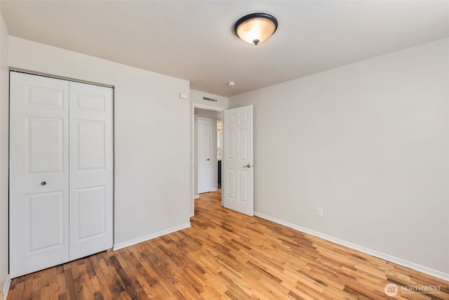 4006 147th Pl, Bellevue, WA 98006 - unfurnished bedroom featuring wood finished floors and a closet
