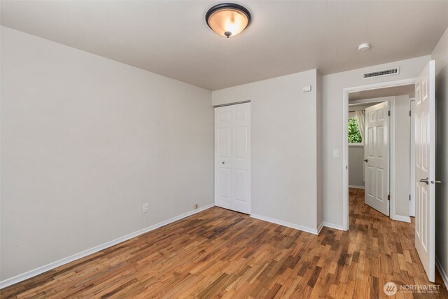 4006 147th Pl, Bellevue, WA 98006 - unfurnished bedroom with wood finished floors and a closet