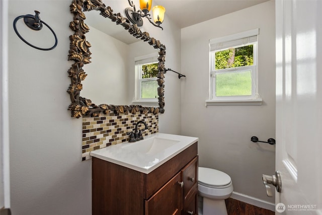 4006 147th Pl, Bellevue, WA 98006 - bathroom with vanity, tasteful backsplash, healthy amount of natural light, and wood finished floors