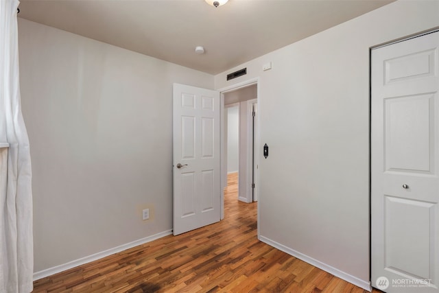 4006 147th Pl, Bellevue, WA 98006 - unfurnished bedroom with baseboards and wood finished floors