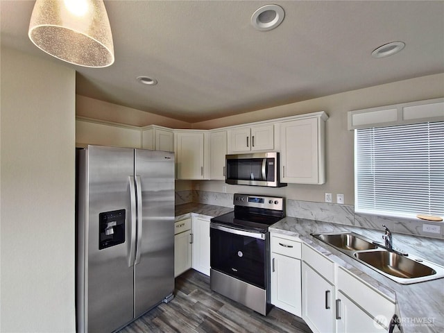 1303 30th Unit 24, Seaview, WA 98640 - kitchen featuring appliances with stainless steel finishes, white cabinets, dark wood finished floors, light countertops, and recessed lighting