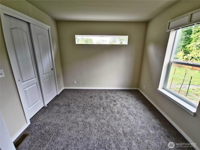 1303 30th Unit 24, Seaview, WA 98640 - unfurnished bedroom featuring dark carpet and a closet