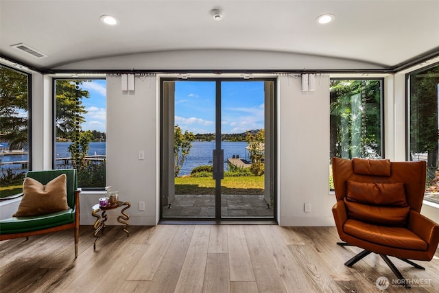 4014 E Mercer Way, Mercer Island, WA 98040 - living area with a water view, lofted ceiling, wood finished floors, healthy amount of natural light, and recessed lighting