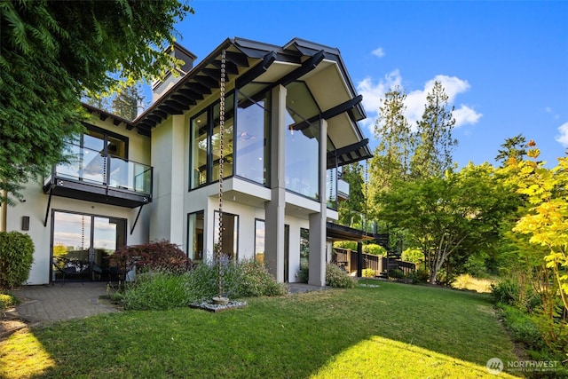 4014 E Mercer Way, Mercer Island, WA 98040 - back of property with stucco siding, a balcony, and a yard