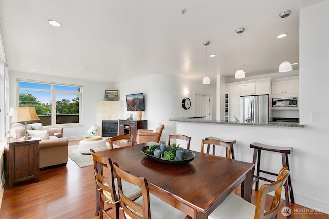 2551 Thorndyke Ave W Unit 302, Seattle, WA 98199 - dining space with wood finished floors, recessed lighting, and a glass covered fireplace