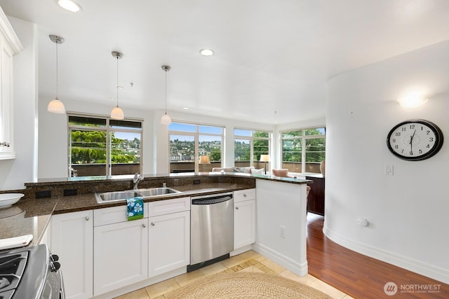 2551 Thorndyke Ave W Unit 302, Seattle, WA 98199 - kitchen featuring stainless steel dishwasher, range, white cabinetry, hanging light fixtures, and recessed lighting