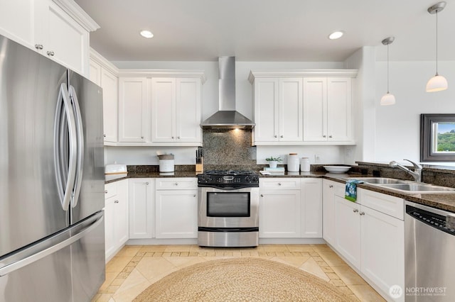 2551 Thorndyke Ave W Unit 302, Seattle, WA 98199 - kitchen featuring appliances with stainless steel finishes, wall chimney range hood, inlaid floor details, white cabinets, and recessed lighting