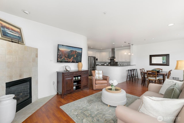 2551 Thorndyke Ave W Unit 302, Seattle, WA 98199 - living room with wood finished floors, recessed lighting, and a tile fireplace