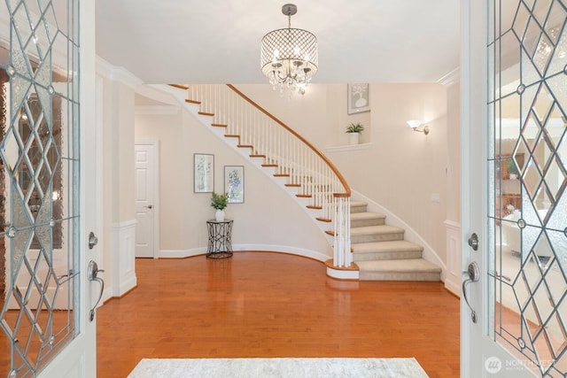 13695 NE 32nd Pl, Bellevue, WA 98005 - foyer with stairway, wood finished floors, crown molding, and a chandelier
