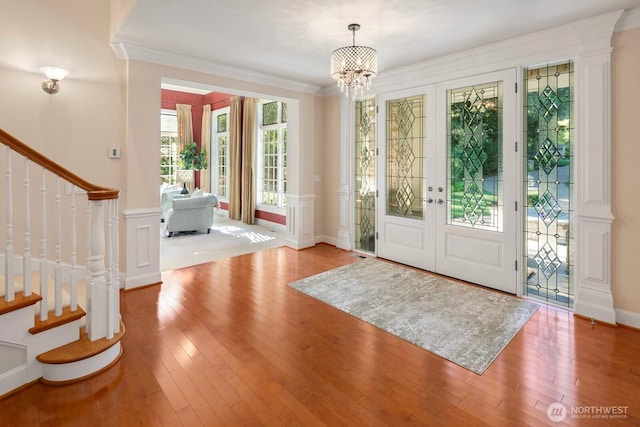 13695 NE 32nd Pl, Bellevue, WA 98005 - entrance foyer with a chandelier, stairway, wood-type flooring, ornamental molding, and french doors
